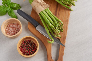 banches of fresh green asparagus on wooden background, fresh asparagus on wooden. group of Fresh asparagus on the wood background, raw vegetable food for health cook. and spices. Healthy food.