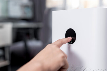 Close up hand a man touching screen monitor of Air purifier for start air filter machine for home...