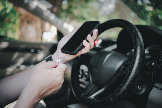 Close up and a man use cable Plug to charge mobile phone in the car : connecting data car play, music,Navigation system and charging mobile in process
