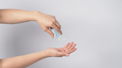 Hands is hold and squeezing alcohol hand gel isoalted on white background.