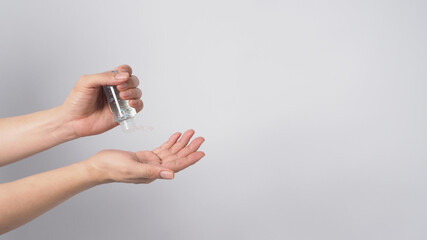 Hands is hold and squeezing alcohol hand gel isoalted on white background.