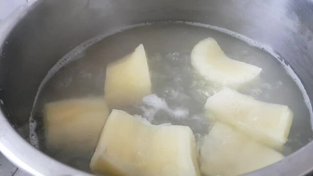 Boiling tapioca cut pieces in a pressure cooker