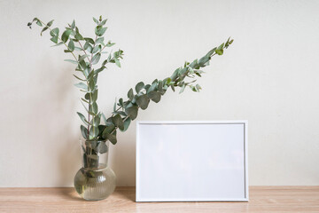 Minimalist home decor with empty frame mock-up on white wall background