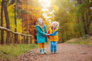 Fototapeta premium Kids play in autumn park. Children in fall.