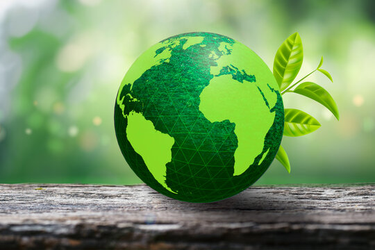 Green globe on wooden floor and natural background bokeh blur. The concept of loving the earth and the environment.