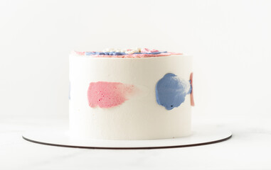 White cake with cream cheese frosting and Happy birthday text on the top.