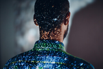 Adult man in the projection of light points on his body