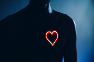 Adult man torso with heart shape on the chest. Healthy human heart