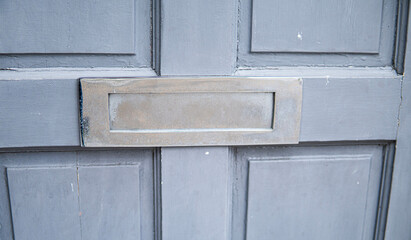 Old letterbox in the door, traditional way of delivering letters to the house, old mailbox, correspondence
