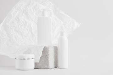 a set of packaging for cosmetics, a blank jar and bottles with creams or lotions, mock up cosmetics product concept