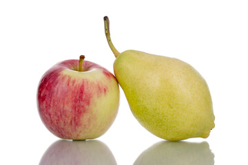 One juicy organic apple and one green pear, close-up, isolated on white.