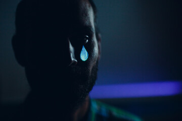 Crying sad man portrait with tears in eye