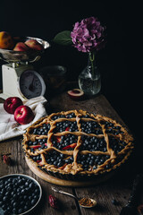 Rustic peach-blueberry-ricotta spelt pie. Step by step process of making pie. Decorating with crust.