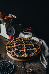 Rustic peach-blueberry-ricotta spelt pie. Step by step process of making pie. Decorating with crust.