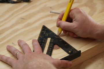 Fototapeta na wymiar carpenter measuring wood