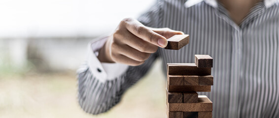 A woman is pulling a block of wood from a row and not breaking it down, like running a good...