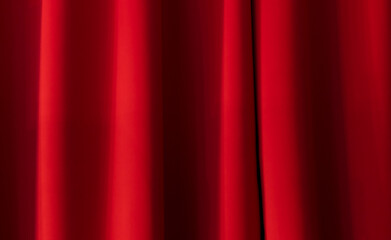 beautiful red draped curtain illuminated by the sun