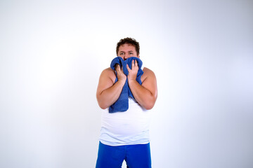 A grown-up funny toast man who is tired and sweating. The guy is drying himself off with a towel. Active sports and weight loss. White background with space for inscriptions.