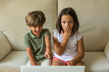 Children At home.
Stock Photo Of A Boy And A Girl At Home Watching A Movie Or Series On The...