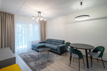 Modern light interior of living room in studio apartment. Furniture.