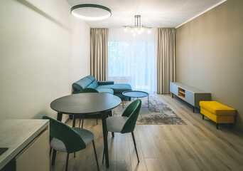 Modern light interior of living room in studio apartment. Furniture.