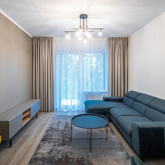 Modern light interior of living room in studio apartment. Furniture.