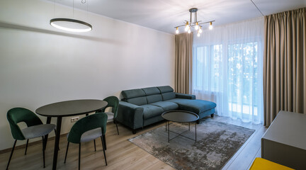 Modern light interior of living room in studio apartment. Furniture.
