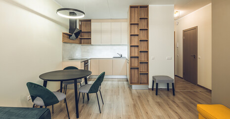 Modern light interior of studio apartment. Kitchen. Living room.
