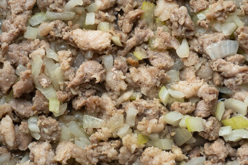 fried minced meat with onions in a frying pan, finely chopped meat background.