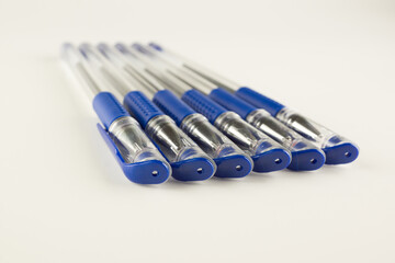 set of blue ballpoint pens lined up hardly