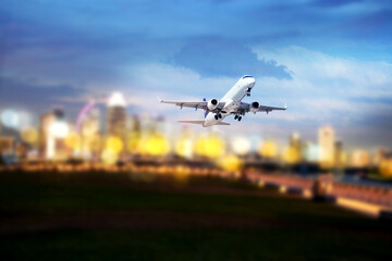 commercial plane taking off blurred city lights in the background