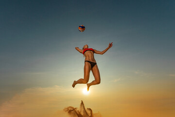 Fototapeta na wymiar Volleyball player. Jump of young girl, playing volleyball on the beach.