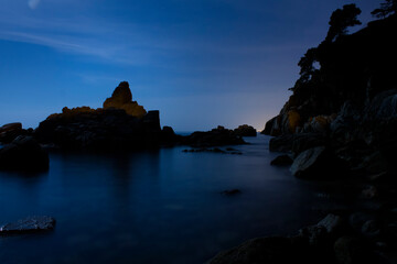 Coastal rocks in a calm sea at dusk © joangasconcomas