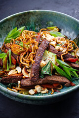 Modern style pad Thai beef with angus roast beef slices, noodles and vegetable served as close-up...