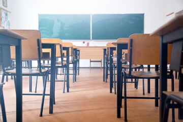 Elementary classroom, no kid or teacher, with chairs and tables. Education concept.