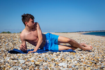 Fototapeta na wymiar Sit ups on a stony beach