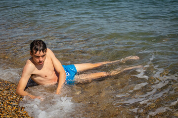 Fototapeta premium Teen boy on the foreshore