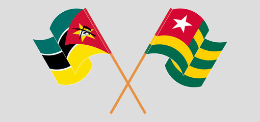 Crossed and waving flags of Mozambique and Togo