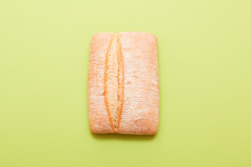 Bread, pastries on a colored bright background. Bread with sesame seeds and seeds, bread texture. Delicious flavored bun.