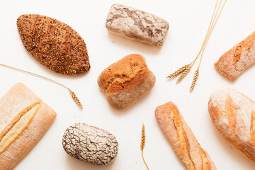 Bread, pastries on a light background. Bread with sesame seeds and seeds, bread texture. Delicious flavored bun. Lots of airy fresh bread.
