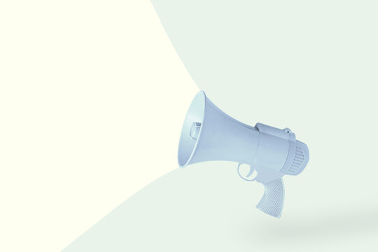 Blue and gray gun megaphone isolated on pale green and yellow background with copy space. Minimal, abstract, creative scene. Killing speech concept. Hate speech, fake news, or hurtful words idea.