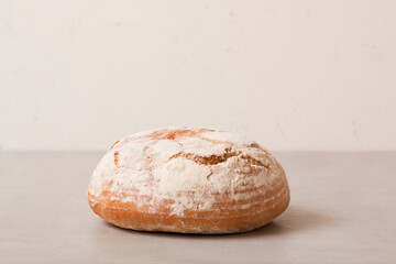 Soft fresh round bread on a light background. Fragrant pastries.