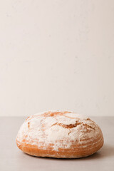Soft fresh round bread on a light background. Fragrant pastries.