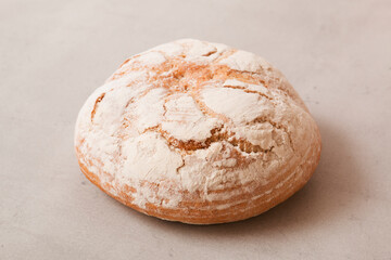 Soft fresh round bread on a light background. Fragrant pastries.