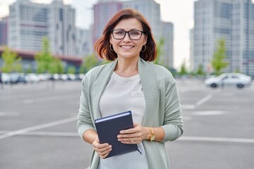 Outdoor portrait of business woman 40s of age