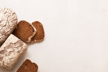 Sliced ​​dark bread. Pieces of bread. Baking on a light background.