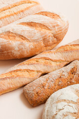 Lots of different fresh breads on a light background. Fragrant airy baked goods. Sliced ​​bread.