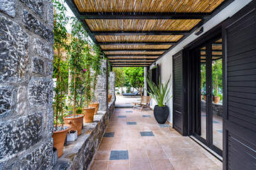 Backyard tiled terrace of house villa with stone semi wall. 