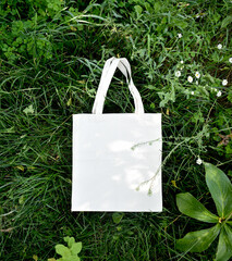 Eco bag on the green grass. Top view. Say NO more plastic and polyethylene bags. The concept of...