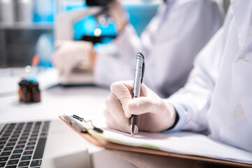 Fototapeta premium Health care researchers working in life science laboratory, medical science technology research work for test a vaccine, coronavirus covid-19 vaccine protection cure treatment